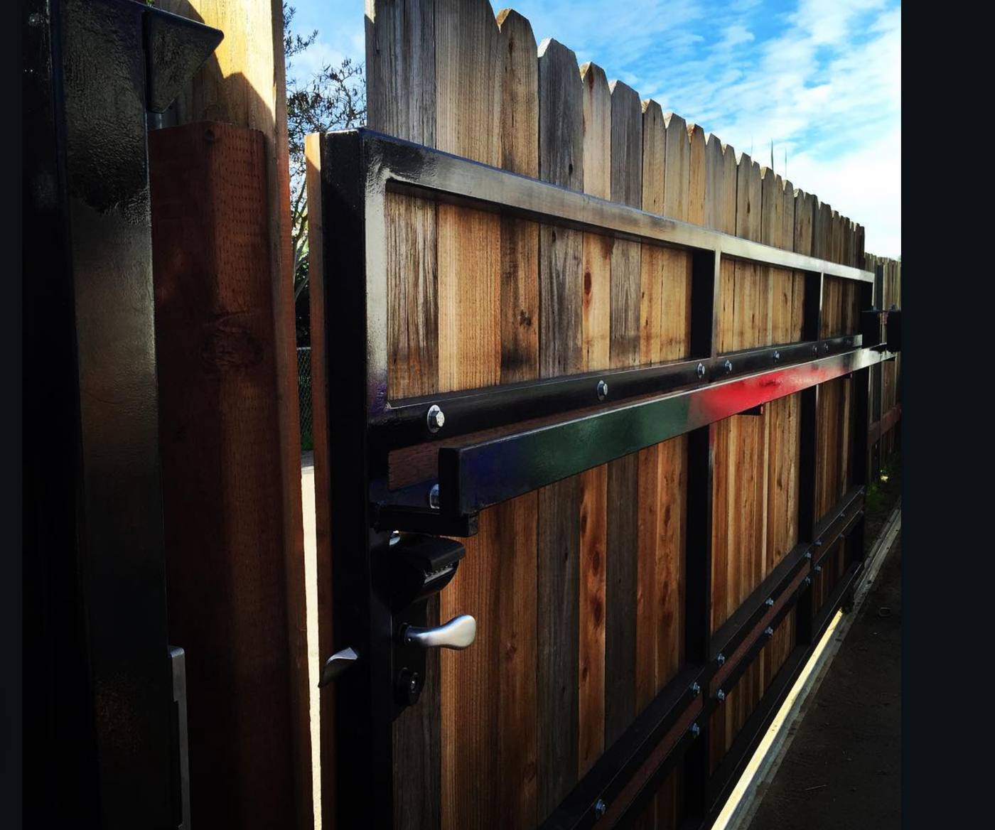 Custom rolling gate with steel frame and cedar boards